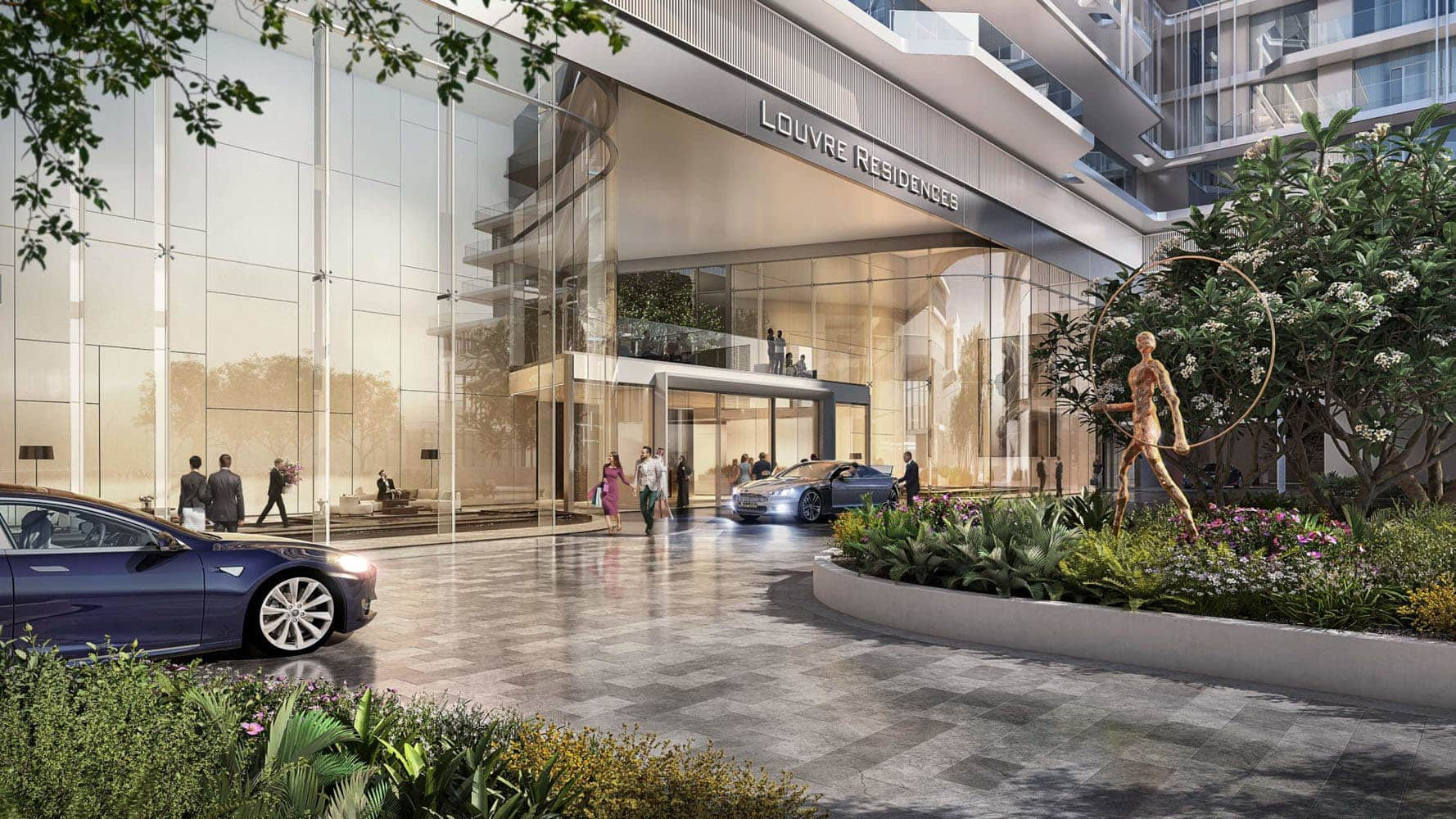 בכניסה לבניין מודרני הנושא את השם “Louvre Residences” באבו דאבי נראים קירות זכוכית, מכוניות יוקרה בחניה, אנשים המטיילים במקום, וכן גן מעוצב עם פסל ברונזה ופרחים צבעוניים מול דירות היוקרה הללו. בכניסה לבניין מודרני הנושא את השם "Louvre Residences" באבו דאבי נראים קירות זכוכית, מכוניות יוקרה בחניה, אנשים המטיילים במקום, וכן גן מעוצב עם פסל ברונזה ופרחים צבעוניים מול דירות היוקרה הללו.