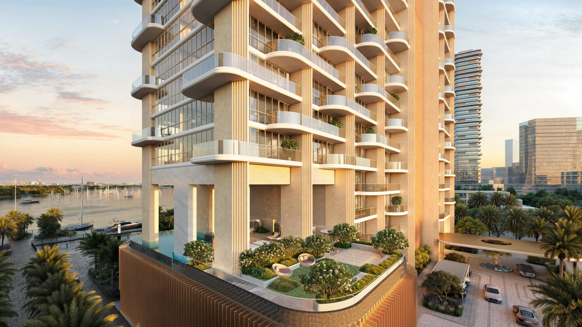 בניין רב-קומות מודרני עם מרפסות גדולות וצמחייה, המשקיף על מרינה עם סירות ועצי דקל בשעת השקיעה. מכוניות חונות ליד הכניסה, וברקע נראים בניינים גבוהים נוספים. בניין רב-קומות מודרני עם מרפסות גדולות וצמחייה, המשקיף על מרינה עם סירות ועצי דקל בשעת השקיעה. מכוניות חונות ליד הכניסה, וברקע נראים בניינים גבוהים נוספים.