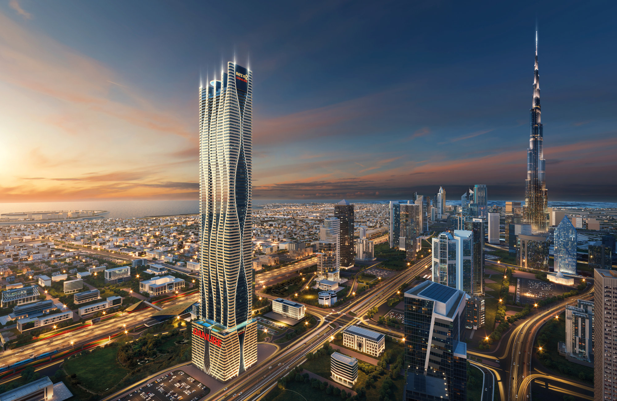 נוף עירוני בשעת השקיעה, ובו גורד שחקים גבוה ומודרני עם אורות זוהרים בקדמת התמונה, מוקף בבניינים רבי קומות אחרים ובכבישים סואנים; מגדל בורג’ חליפה מתנשא ברקע. נוף עירוני בשעת השקיעה, ובו גורד שחקים גבוה ומודרני עם אורות זוהרים בקדמת התמונה, מוקף בבניינים רבי קומות אחרים ובכבישים סואנים; מגדל בורג' חליפה מתנשא ברקע.