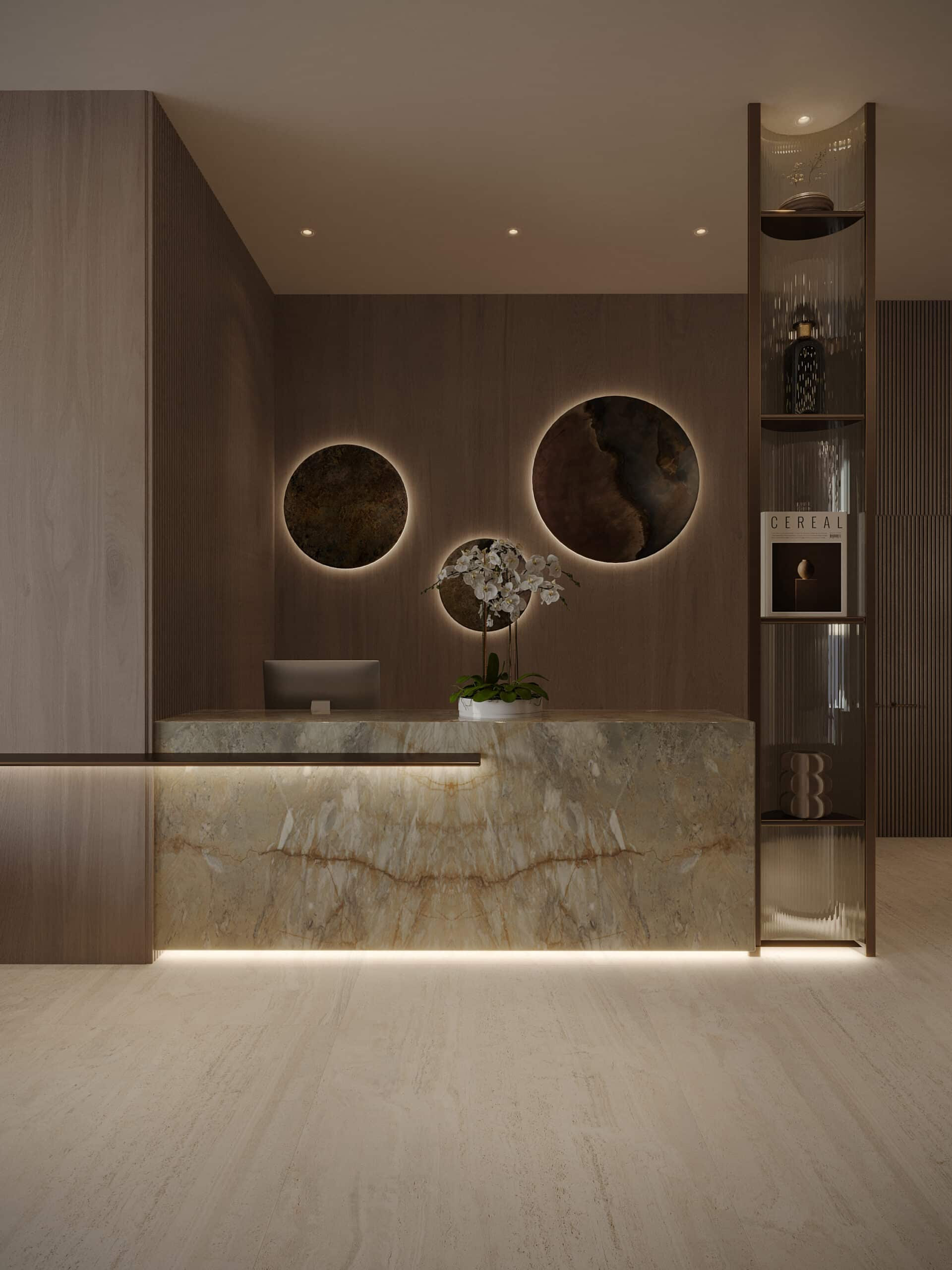 דלפק הקבלה המודרני והמינימליסטי ב-Pearl House 3 כולל חזית משיש, צג מחשב וסחלב לבן. מאחוריו תלויים שני יצירות אמנות עגולות עם תאורה אחורית, ומימין ניצב מדף גבוה שעליו מונחים ספרים וחפצי נוי. דלפק הקבלה המודרני והמינימליסטי ב-Pearl House 3 כולל חזית משיש, צג מחשב וסחלב לבן. מאחוריו תלויים שני יצירות אמנות עגולות עם תאורה אחורית, ומימין ניצב מדף גבוה שעליו מונחים ספרים וחפצי נוי.