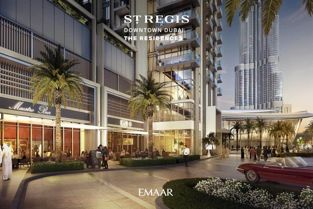 בניין יוקרתי ומודרני בשם “St-Rergis Downtown Dubai The Residences”, עם עצי דקל, אנשים המטיילים, מסעדות בחוץ ובורג’ חליפה ברקע; לוגו של EMAAR בתחתית התמונה. בניין יוקרתי ומודרני בשם "St-Rergis Downtown Dubai The Residences", עם עצי דקל, אנשים המטיילים, מסעדות בחוץ ובורג' חליפה ברקע; לוגו של EMAAR בתחתית התמונה.