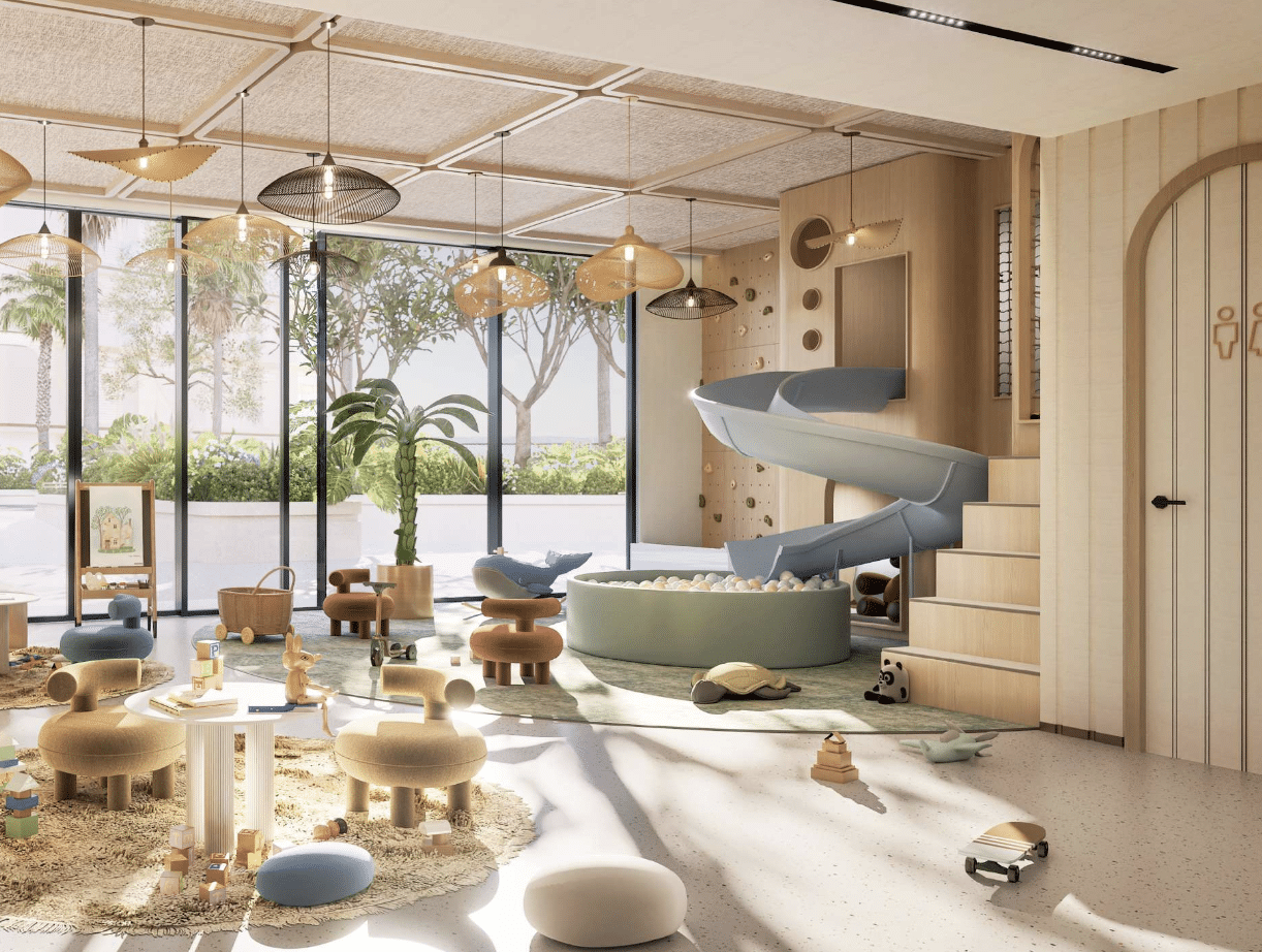 חדר משחקים מקורה, מרווח ומודרני במתחם “Fahid Beach Residence”, הכולל חלונות גדולים, מגלשה כחולה המובילה לבריכת כדורים, פינות ישיבה רכות, צעצועים, שולחנות נמוכים ותאורה טבעית. מבעד לקירות הזכוכית ניתן לראות את הצמחייה שבחוץ. חדר משחקים מקורה, מרווח ומודרני במתחם "Fahid Beach Residence", הכולל חלונות גדולים, מגלשה כחולה המובילה לבריכת כדורים, פינות ישיבה רכות, צעצועים, שולחנות נמוכים ותאורה טבעית. מבעד לקירות הזכוכית ניתן לראות את הצמחייה שבחוץ.