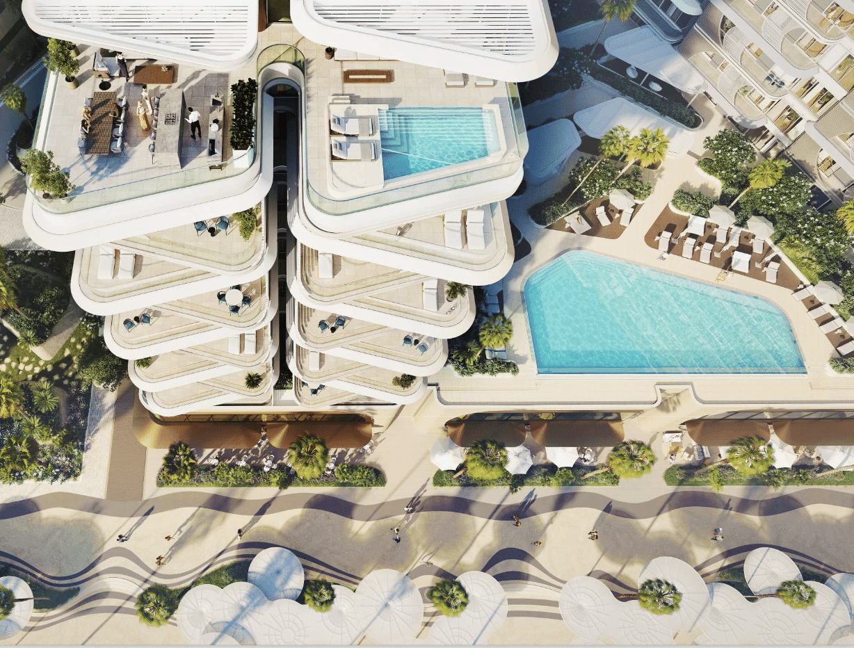 מבט אווירי על “Fahid Beach Residence”, אתר נופש מודרני הכולל מבנים מדורגים עם בריכות גג, מיטות שיזוף ובריכת שחייה מרכזית גדולה המוקפת עצי דקל ושבילי הליכה. מבט אווירי על "Fahid Beach Residence", אתר נופש מודרני הכולל מבנים מדורגים עם בריכות גג, מיטות שיזוף ובריכת שחייה מרכזית גדולה המוקפת עצי דקל ושבילי הליכה.