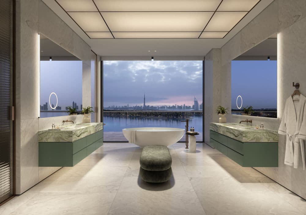 חדר רחצה יוקרתי ומודרני במלון Six Senses Palm Jumeirah, הכולל אמבטיה עומדת, כיורי רחצה צפים בצבע ירוק, מראות גדולות וחלונות רחבים המשקיפים על נוף עירוני מרהיב ועל השקיעה מעל קו החוף. רצפות השיש והתאורה העדינה יוצרים אווירה שלווה. חדר רחצה יוקרתי ומודרני במלון Six Senses Palm Jumeirah, הכולל אמבטיה עומדת, כיורי רחצה צפים בצבע ירוק, מראות גדולות וחלונות רחבים המשקיפים על נוף עירוני מרהיב ועל השקיעה מעל קו החוף. רצפות השיש והתאורה העדינה יוצרים אווירה שלווה.