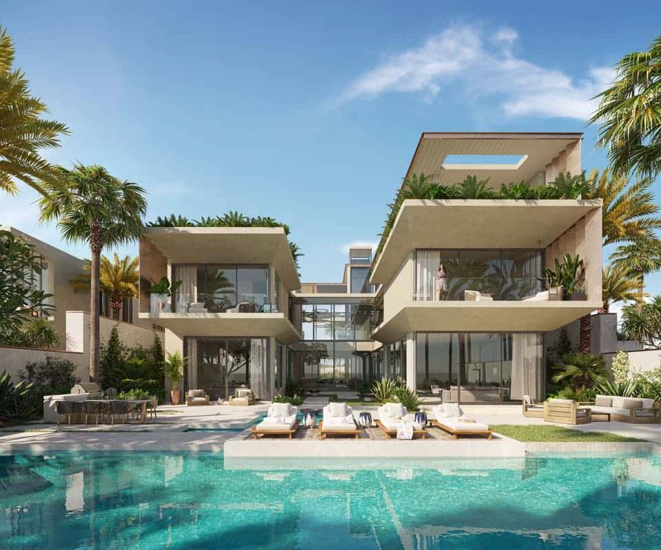 וילה יוקרתית ומודרנית בהשראת רשת Six Senses, עם חלונות זכוכית גדולים, מרפסות רבות עם צמחייה, ופטיו מרווח המשקיף על בריכת השחייה. עצי דקל וכסאות נוח מקיפים את הבריכה תחת שמי פאלם ג’ומיירה הכחולים והבהירים. וילה יוקרתית ומודרנית בהשראת רשת Six Senses, עם חלונות זכוכית גדולים, מרפסות רבות עם צמחייה, ופטיו מרווח המשקיף על בריכת השחייה. עצי דקל וכסאות נוח מקיפים את הבריכה תחת שמי פאלם ג'ומיירה הכחולים והבהירים.