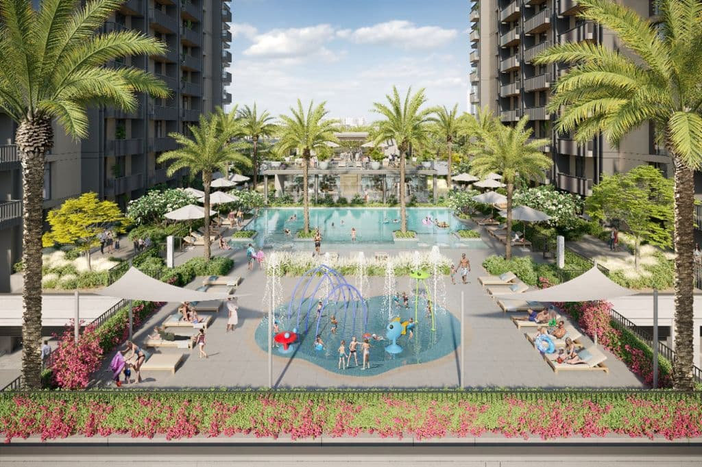 בחצר מתחם הדירות המודרני ב-Kensington Waters יש בריכת שחייה גדולה, אזור משחקים לילדים עם מזרקות, עצי דקל, כסאות נוח, שמשיות, ואנשים שמבלים ומשתעשעים תחת שמיים שטופי שמש. בחצר מתחם הדירות המודרני ב-Kensington Waters יש בריכת שחייה גדולה, אזור משחקים לילדים עם מזרקות, עצי דקל, כסאות נוח, שמשיות, ואנשים שמבלים ומשתעשעים תחת שמיים שטופי שמש.
