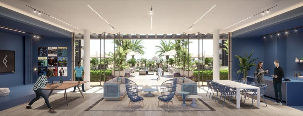 טרקלין מודרני בעיצוב פתוח ב-Kensington Waters, עם עיצוב כחול, שולחנות ופינות ישיבה. אנשים משחקים טניס שולחן, משוחחים ועובדים. חלונות גדולים משקיפים על פטיו חיצוני עם עצי דקל ועוד אנשים שמבלים בו. טרקלין מודרני בעיצוב פתוח ב-Kensington Waters, עם עיצוב כחול, שולחנות ופינות ישיבה. אנשים משחקים טניס שולחן, משוחחים ועובדים. חלונות גדולים משקיפים על פטיו חיצוני עם עצי דקל ועוד אנשים שמבלים בו.