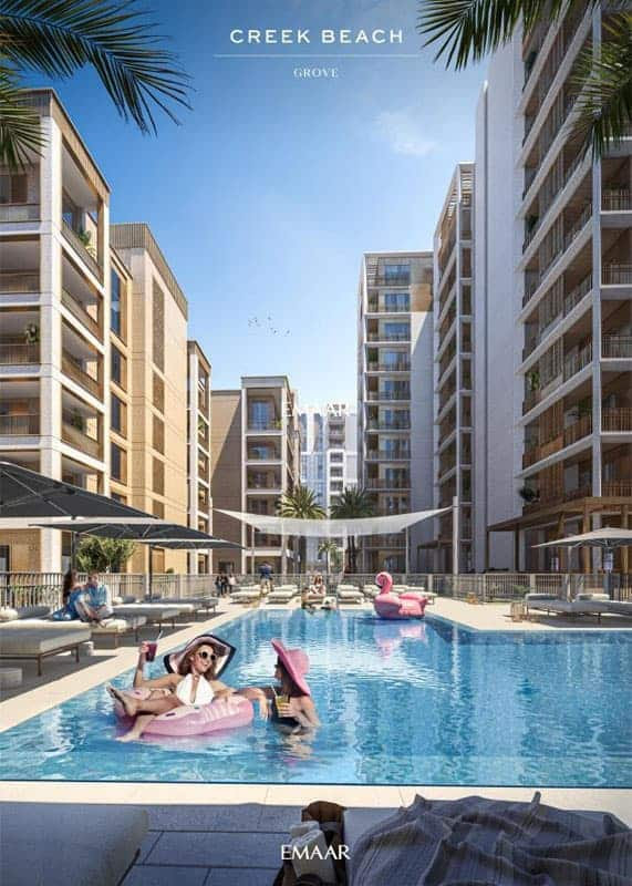 מתחם מגורים מודרני בחוף קריק בדובאי כולל בניינים רב-קומתיים המקיפים בריכת שחייה חיצונית מרכזית. אנשים נרגעים על מצופים וכסאות נוח תחת שמשיות, כשעצי דקל ושמיים כחולים תורמים לאווירה התוססת, הדומה לזו שבאתר נופש. מתחם מגורים מודרני בחוף קריק בדובאי כולל בניינים רב-קומתיים המקיפים בריכת שחייה חיצונית מרכזית. אנשים נרגעים על מצופים וכסאות נוח תחת שמשיות, כשעצי דקל ושמיים כחולים תורמים לאווירה התוססת, הדומה לזו שבאתר נופש.