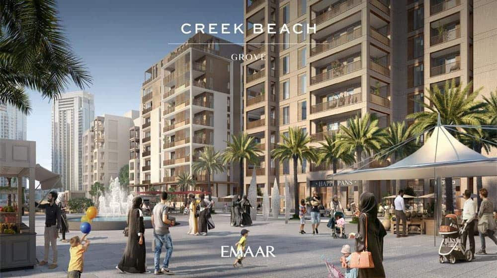 בבניין הדירות המודרני עם המרפסות ב-Creek Beach Grove נשקף נוף אל כיכר תוססת, שבה אנשים מטיילים, ילדים משחקים בין עצי הדקל, ועגלות תינוקות מסתובבות סביב המזרקה. פינות ישיבה בחוץ ושלט “Creek Beach Grove Emaar” משלימים את התמונה התוססת. בבניין הדירות המודרני עם המרפסות ב-Creek Beach Grove נשקף נוף אל כיכר תוססת, שבה אנשים מטיילים, ילדים משחקים בין עצי הדקל, ועגלות תינוקות מסתובבות סביב המזרקה. פינות ישיבה בחוץ ושלט "Creek Beach Grove Emaar" משלימים את התמונה התוססת.