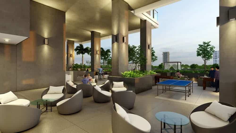 טרקלין החוץ המודרני ב-Catch Residences כולל כיסאות מרופדים, שולחנות עגולים, עציצים ושולחן פינג-פונג תחת גג גדול, המשקיף על הצמחייה ועל בנייני העיר ברקע בשעת בין ערביים. טרקלין החוץ המודרני ב-Catch Residences כולל כיסאות מרופדים, שולחנות עגולים, עציצים ושולחן פינג-פונג תחת גג גדול, המשקיף על הצמחייה ועל בנייני העיר ברקע בשעת בין ערביים.