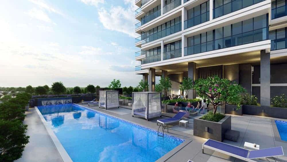 Catch Residences מציע בניין דירות מודרני עם בריכת גג, מיטות שיזוף, בקתות נופש וצמחייה מעוצבת. הדיירים נרגעים לצד הבריכה תחת שמיים בהירים עם עננים פזורים. Catch Residences מציע בניין דירות מודרני עם בריכת גג, מיטות שיזוף, בקתות נופש וצמחייה מעוצבת. הדיירים נרגעים לצד הבריכה תחת שמיים בהירים עם עננים פזורים.