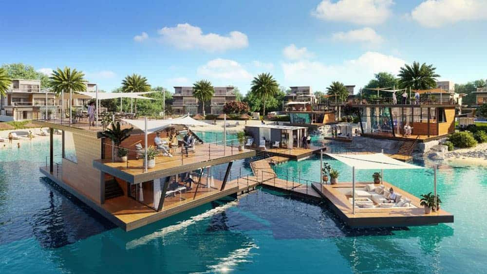 הווילות הצפות המודרניות ב-Damac Lagoons כוללות מרפסות שיזוף, פינות ישיבה חיצוניות ושבילי עץ המשתרעים על פני המים הכחולים והצלולים, מוקפות בעצי דקל ובבניינים עכשוויים בהשראת פורטופינו, תחת שמיים שטופי שמש. הווילות הצפות המודרניות ב-Damac Lagoons כוללות מרפסות שיזוף, פינות ישיבה חיצוניות ושבילי עץ המשתרעים על פני המים הכחולים והצלולים, מוקפות בעצי דקל ובבניינים עכשוויים בהשראת פורטופינו, תחת שמיים שטופי שמש.