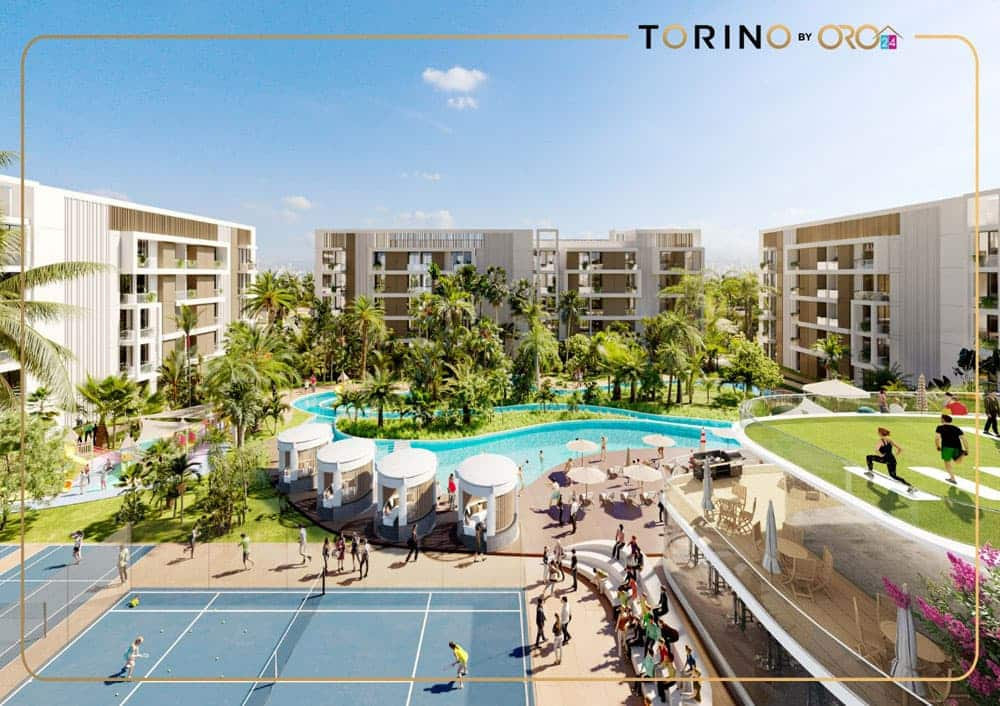מתחם מגורים מודרני של “Torino by ORO24”, הכולל בניינים בני מספר קומות, בריכת שחייה מרכזית, מגרשי טניס, עצי דקל ואנשים הנהנים מפעילויות פנאי תחת שמיים שטופי שמש. לוגו המותג “Torino by ORO” מופיע בחלק העליון. מתחם מגורים מודרני של "Torino by ORO24", הכולל בניינים בני מספר קומות, בריכת שחייה מרכזית, מגרשי טניס, עצי דקל ואנשים הנהנים מפעילויות פנאי תחת שמיים שטופי שמש. לוגו המותג "Torino by ORO" מופיע בחלק העליון.